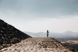 man-prays-on-stone-temple-ledge